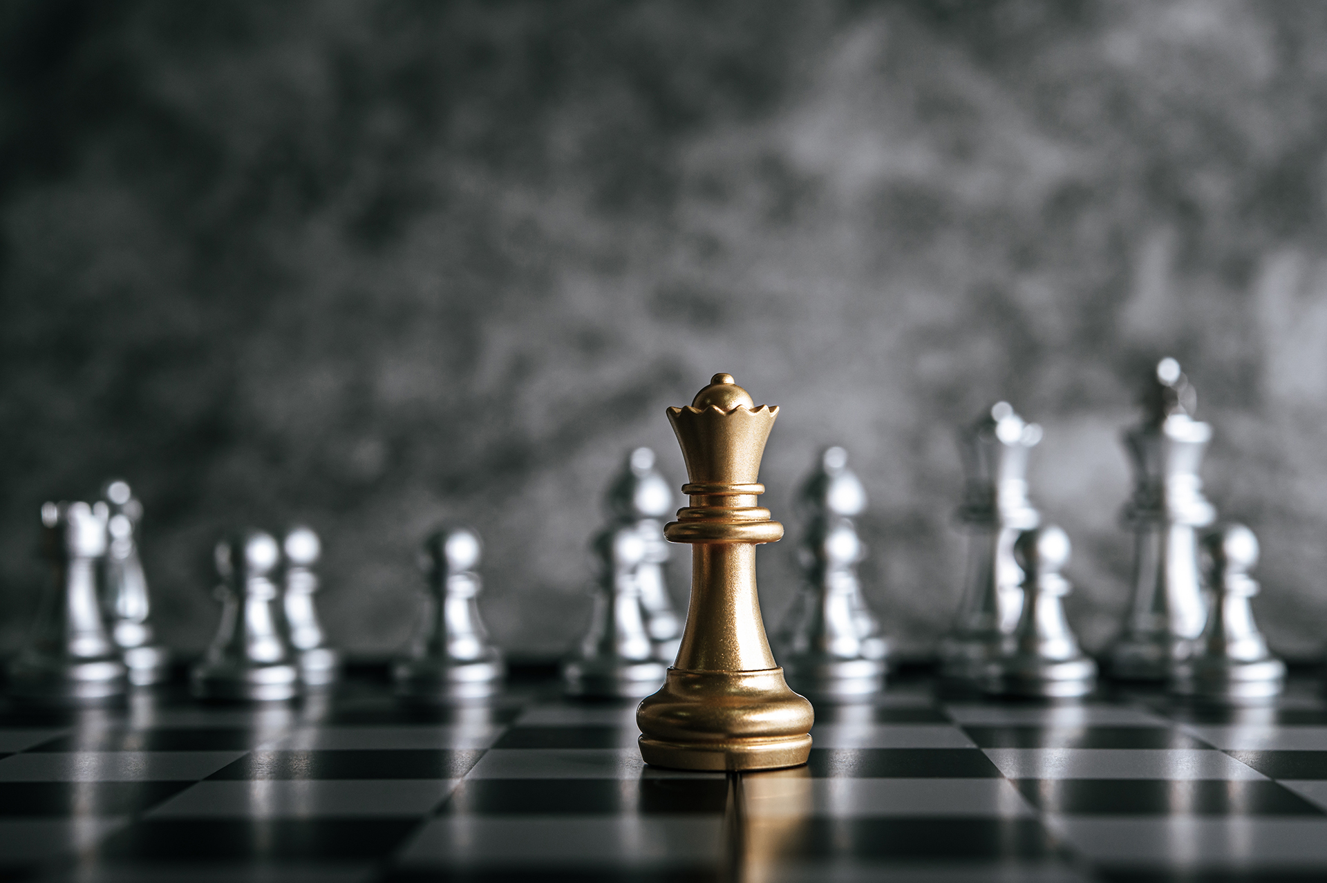 Gold and silver chess pieces representing strategic business leadership